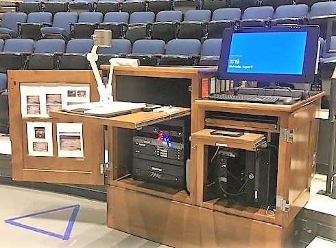 A view of the open instructor cabinet with computer monitor, VGA and HDMI inputs, touch panel controller, document camera, and audiovisual rack.