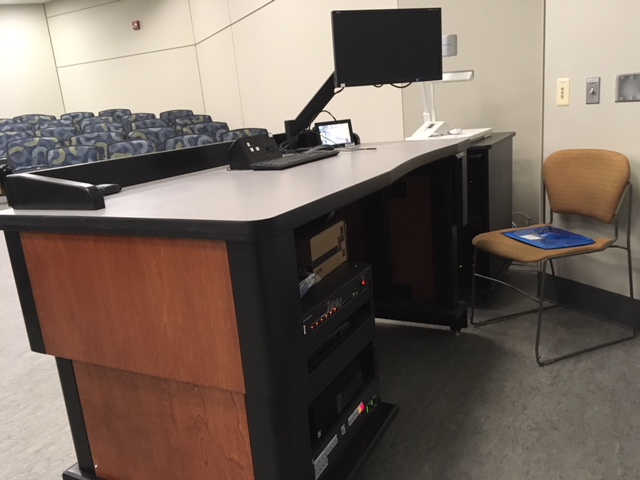 A view of the open cabinet with a computer monitor, PC, HDMI input, Document Camera, BluRay player, a touch panel controller, and audio visual rack.