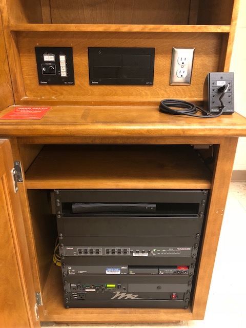 A view of the open cabinet with push button controller, Blu-Ray DVD player, Audio Visual rack, and HDMI input.