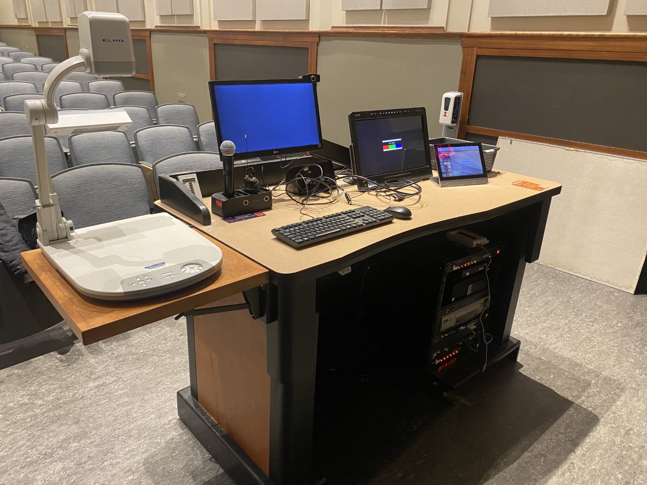 A view of the open cabinet with a computer monitor, VGA, and HDMI inputs, a touch panel controller, document camera, and audiovisual rack.