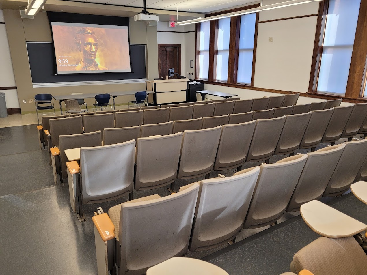 A view of the classroom with Theatre Auditorium Seating and chalkboard in front.