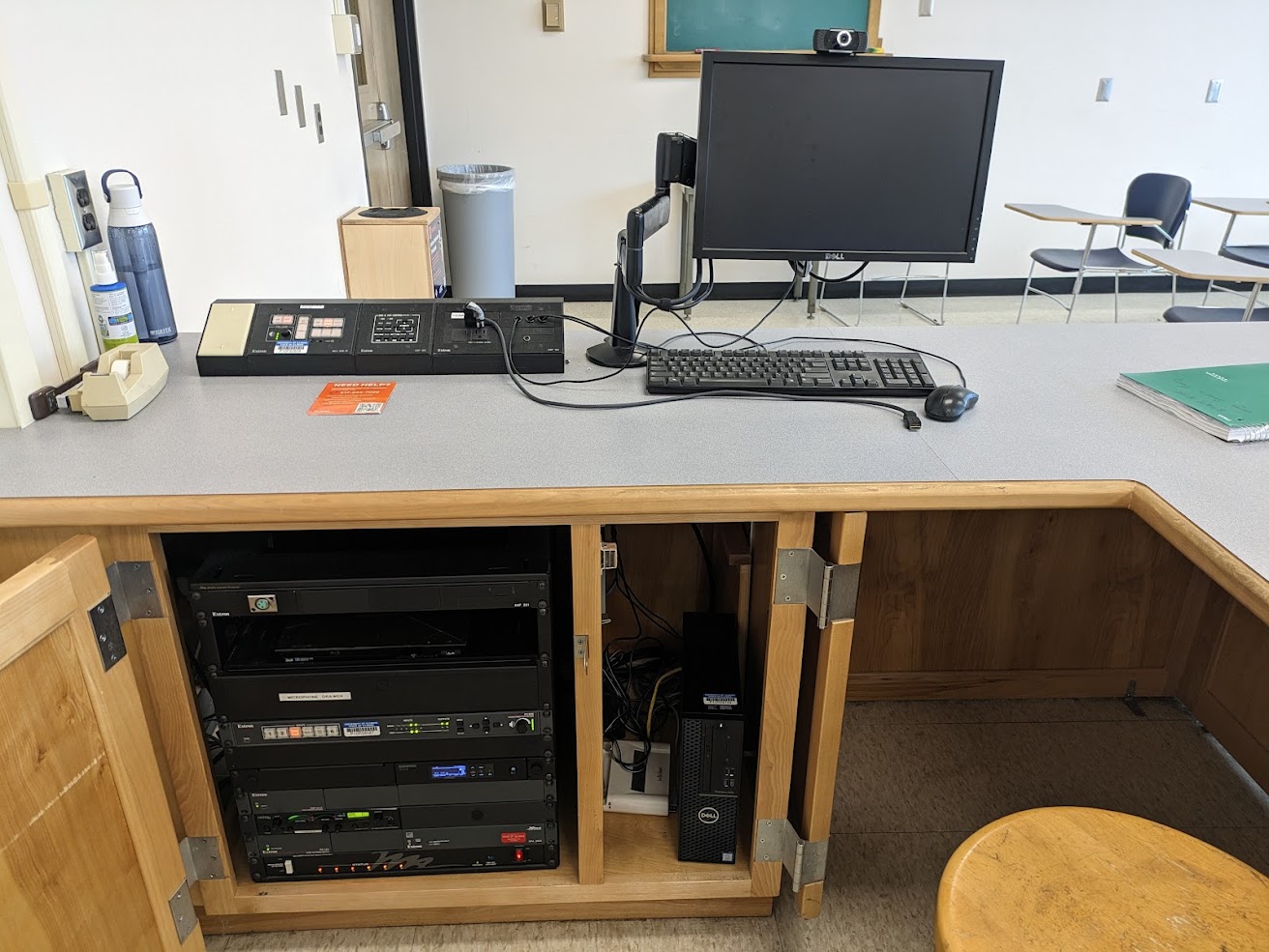 A view of the open cabinet with computer monitor, HDMI input, push button controller, and audio visual rack.