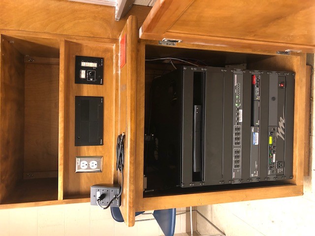 A view of the open cabinet with HDMI input, Wireless Input, Blu-Ray DVD, and push button controller. 