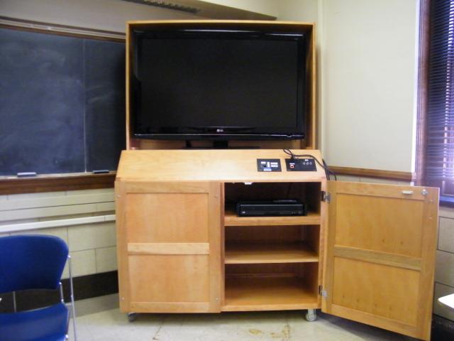 A view of the open cabinet with a high definition LCD monitor, VGA and HDMI inputs, and a push button controller.