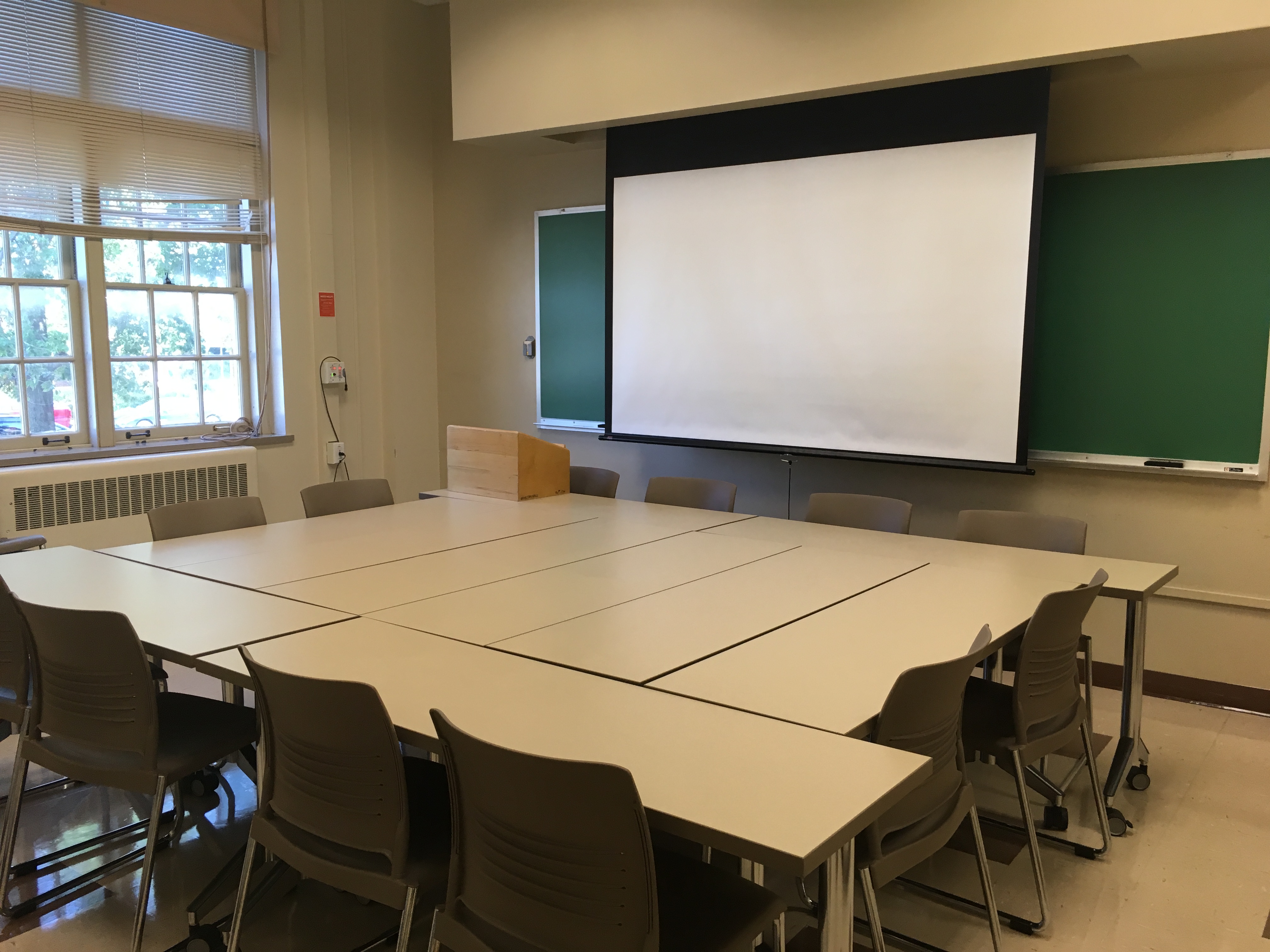 This is a view of the room, with student desks, and a chalkboard.