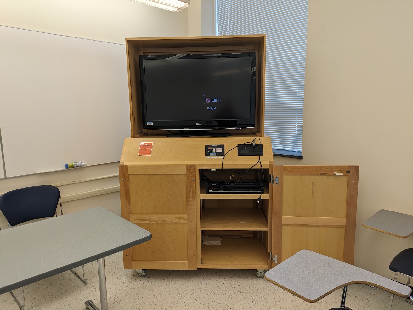 A view of the cabinet open with High Definition LCD Monitor, HDMI input, push button controller, and audio visual rack.