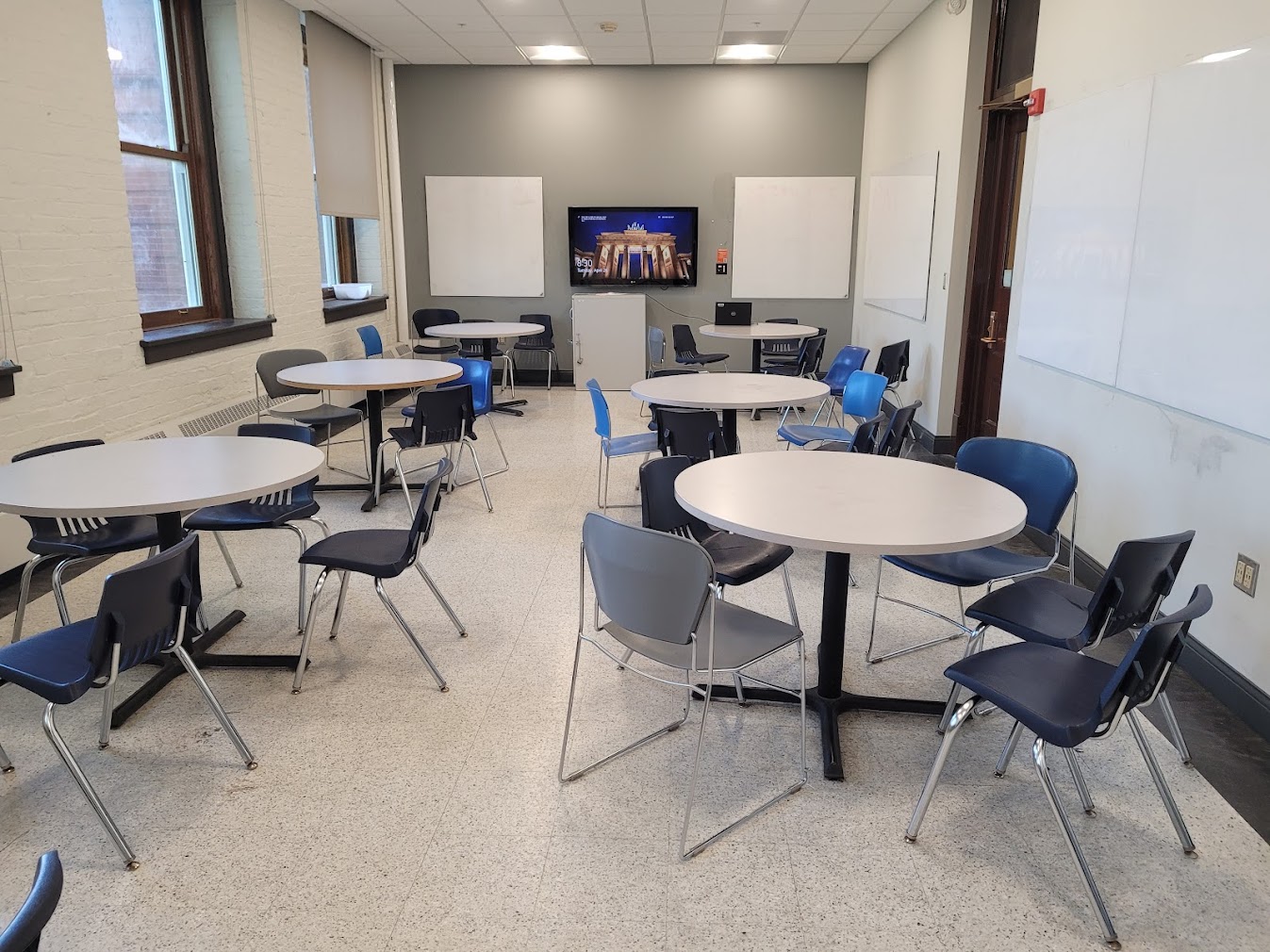 This is a view of the room with student desks, a LCD monitor, and white boards
