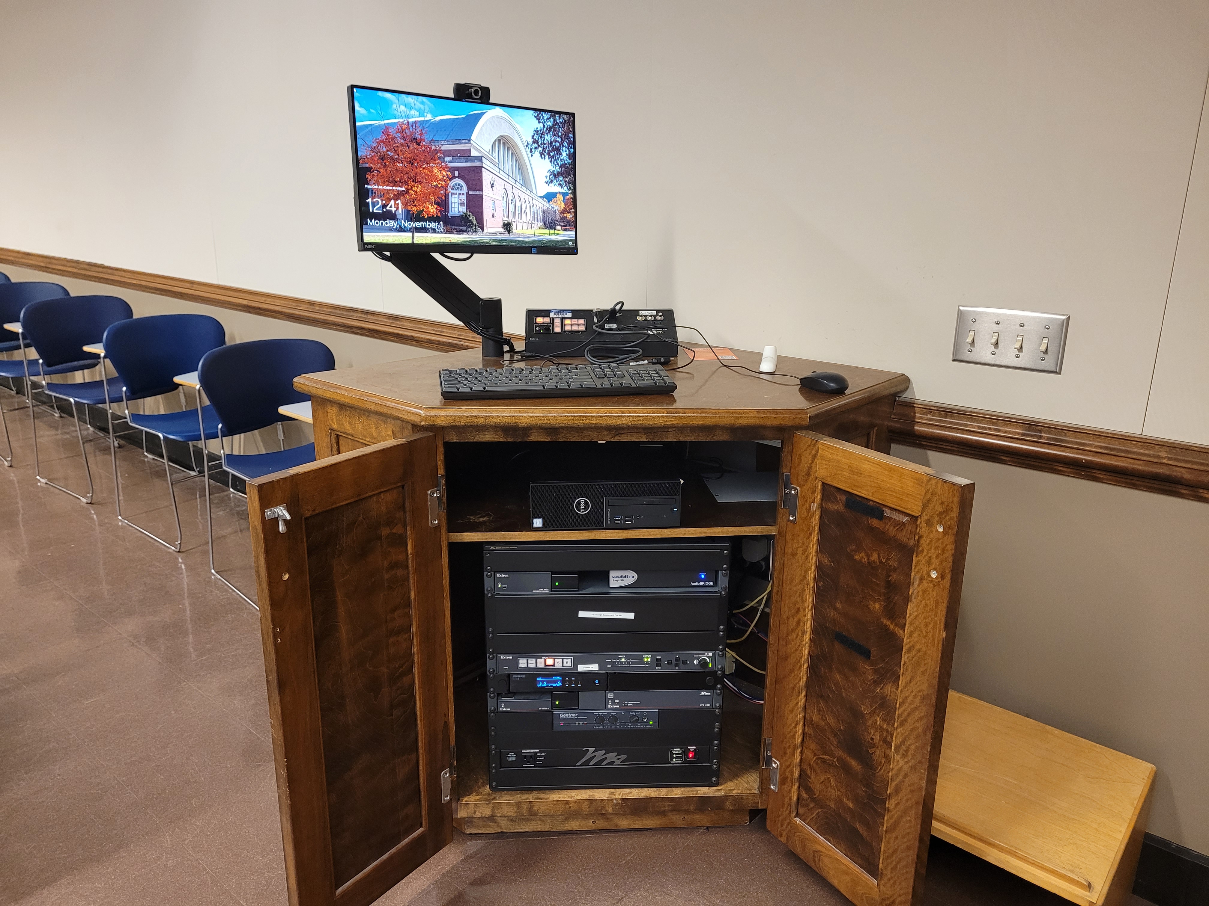 A view of the open cabinet PC, HDMI and Wireless inputs, a push button controller, and audio visual rack.